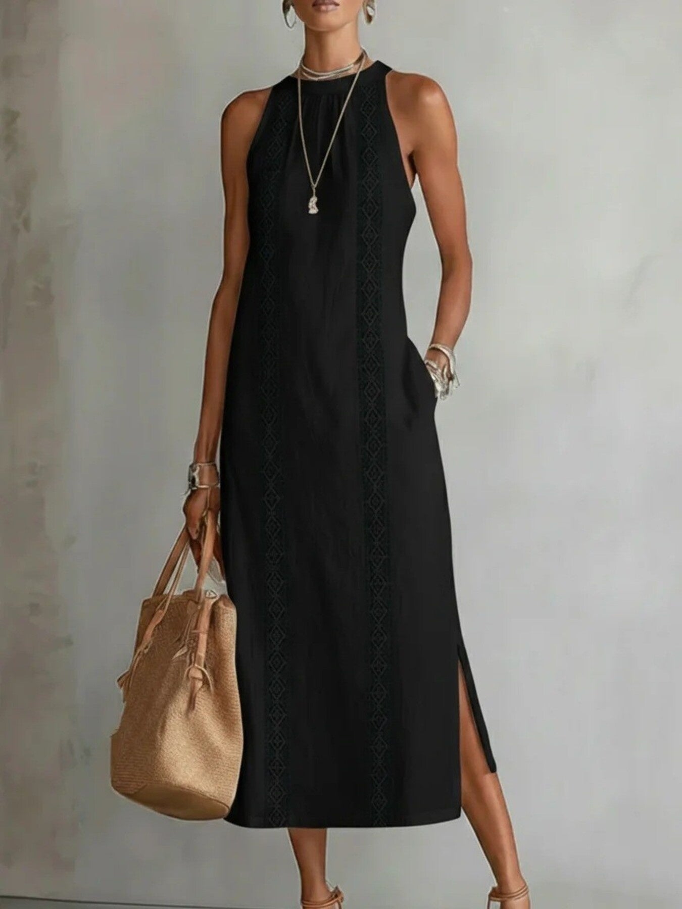 Woman wearing a black dress holding a beige handbag against a plain background